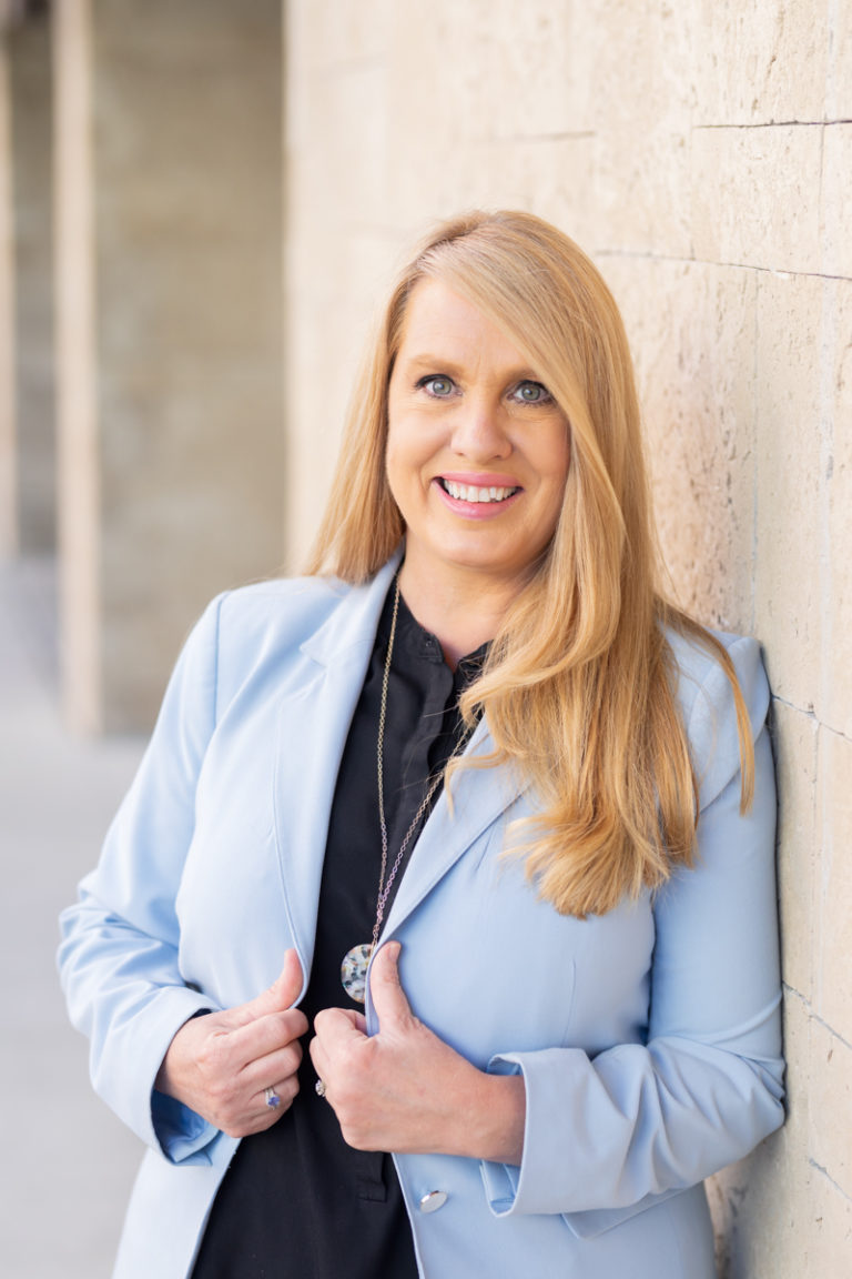 Woman holding lapel of jacket