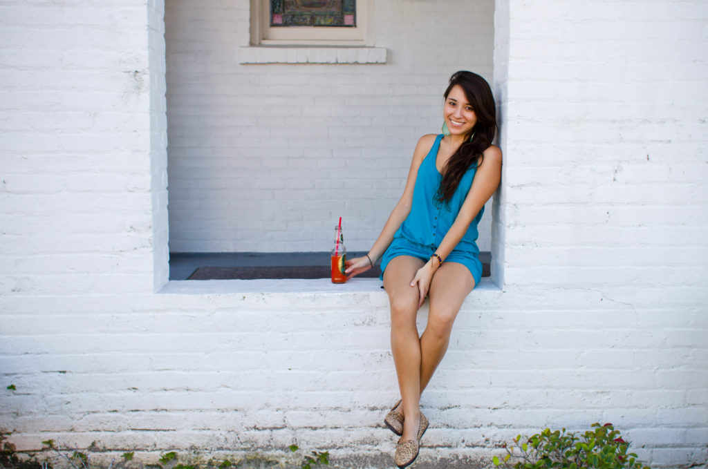 girl sitting on brick wall with vintage soda