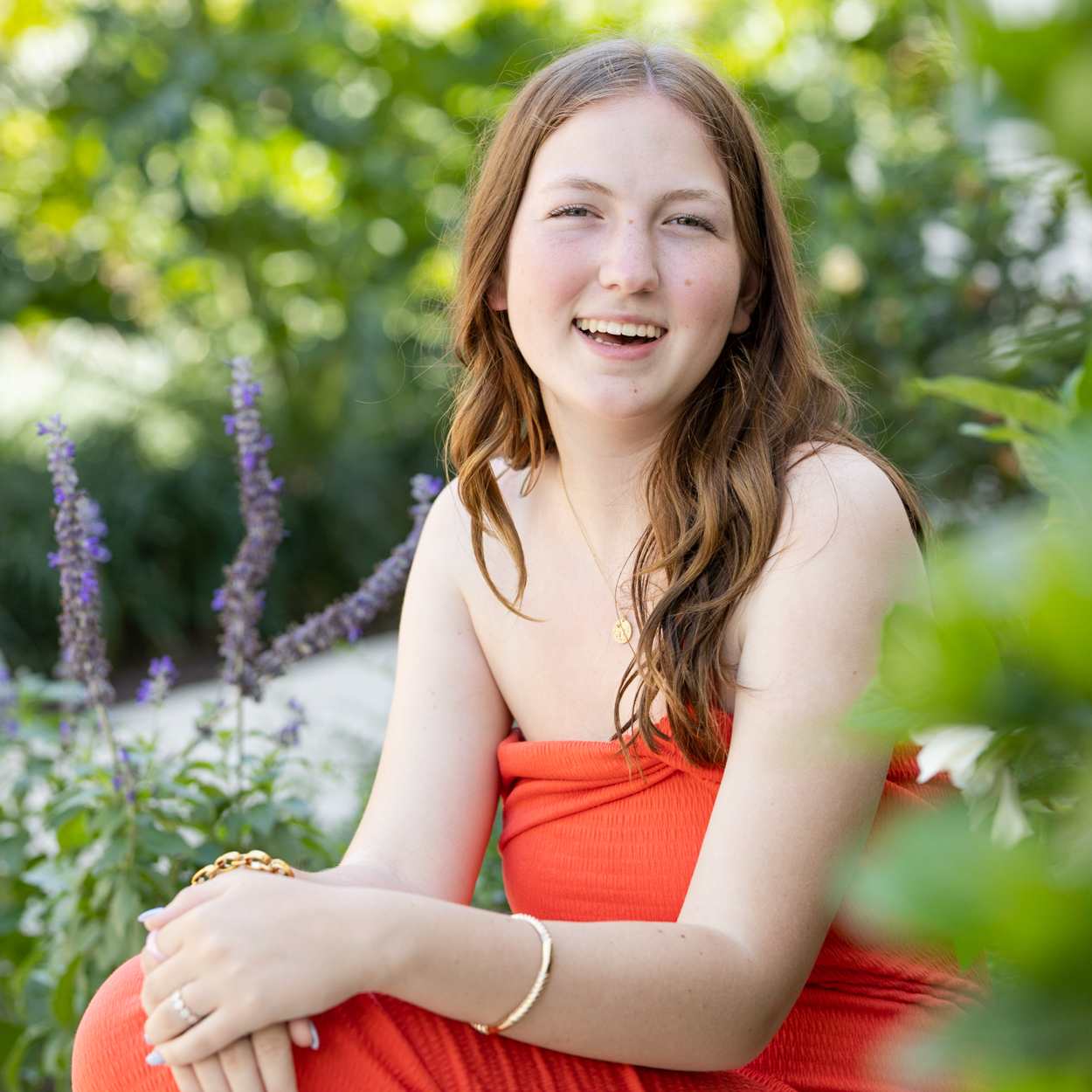 college girl with flowers in foreground and background
