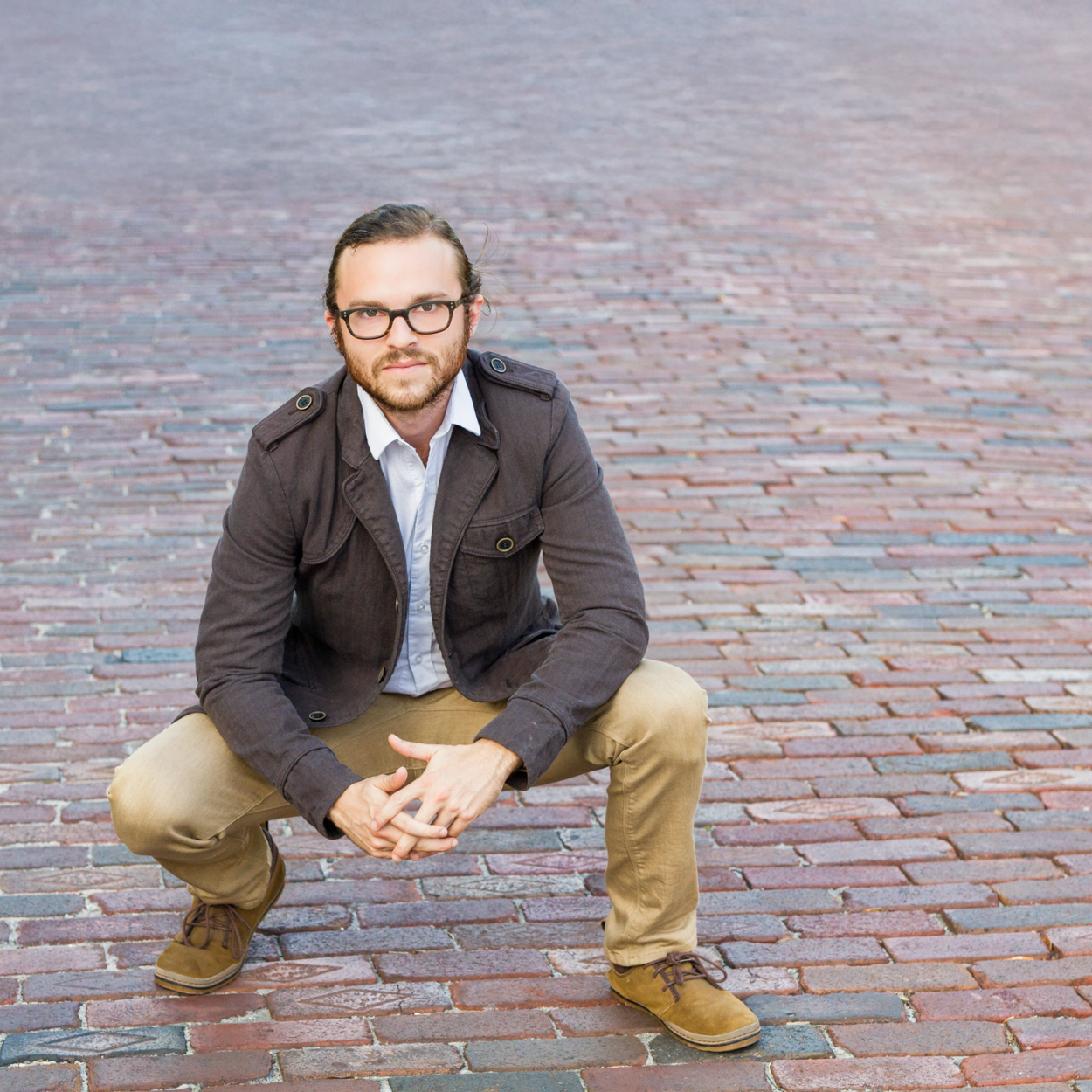 man squatting for a photo pose