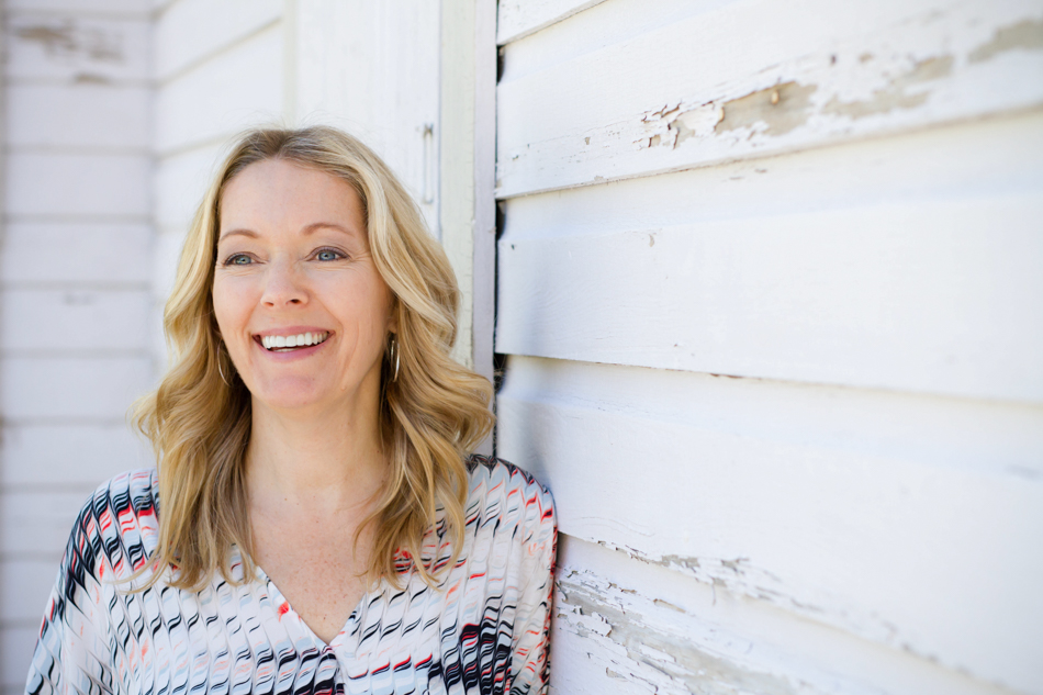 Woman posing on worn shiplap wall