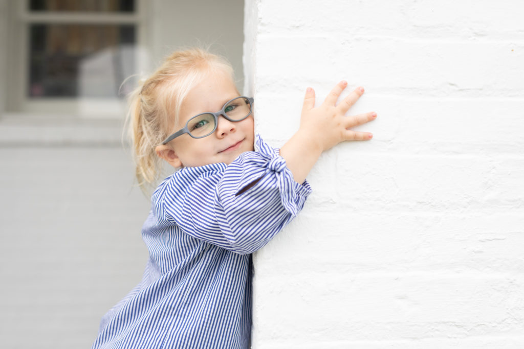 3 year old hugging a brick wall