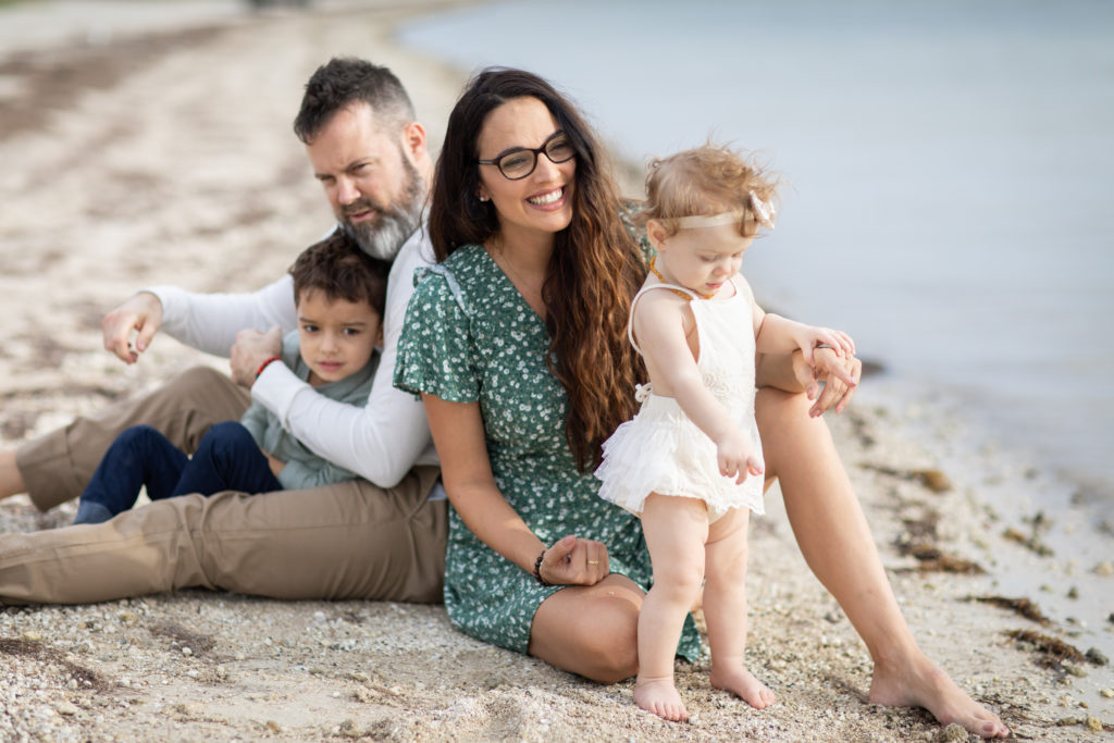 family with two young kids at the beach