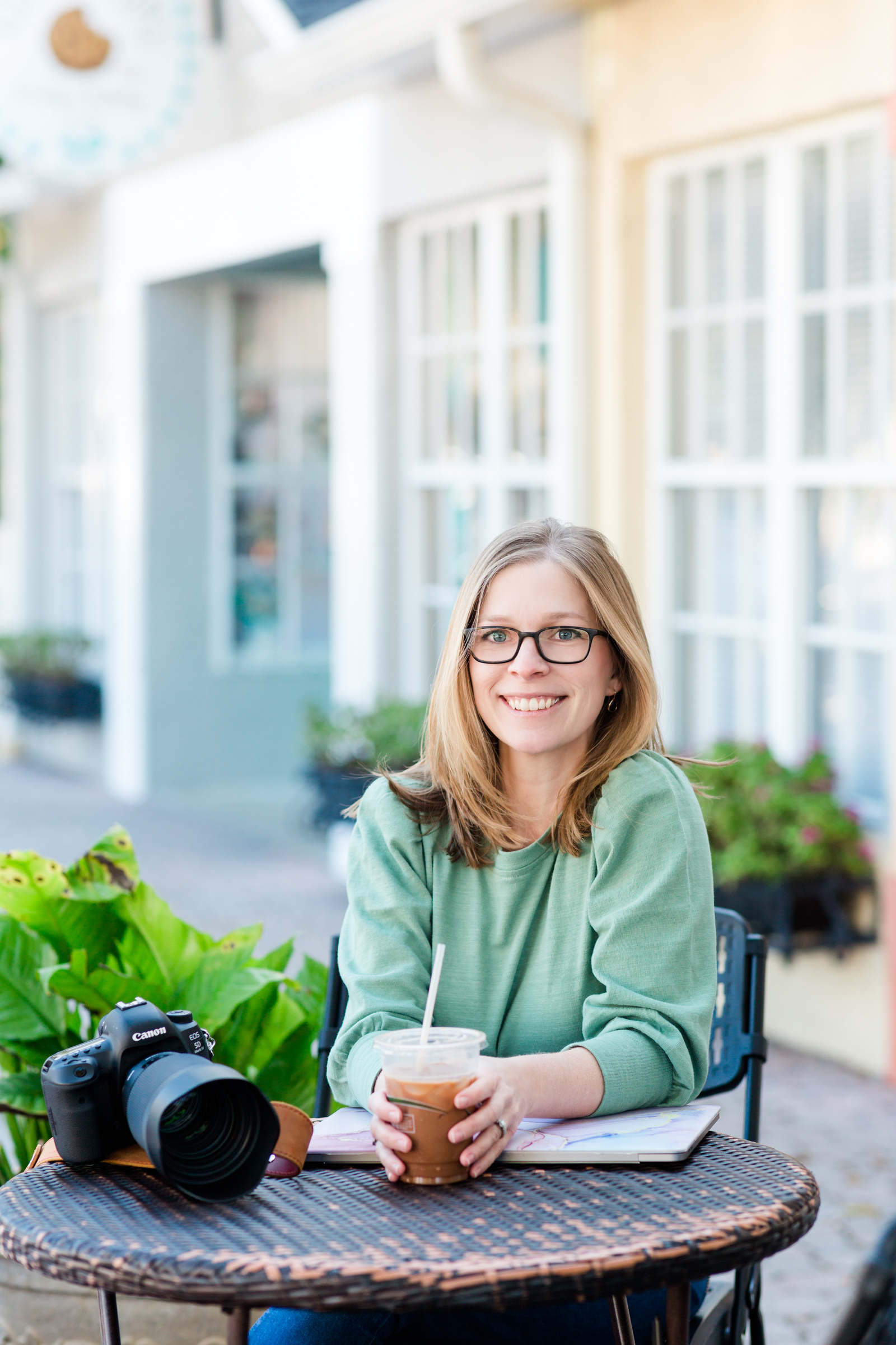 photographer posing with coffee and camera
