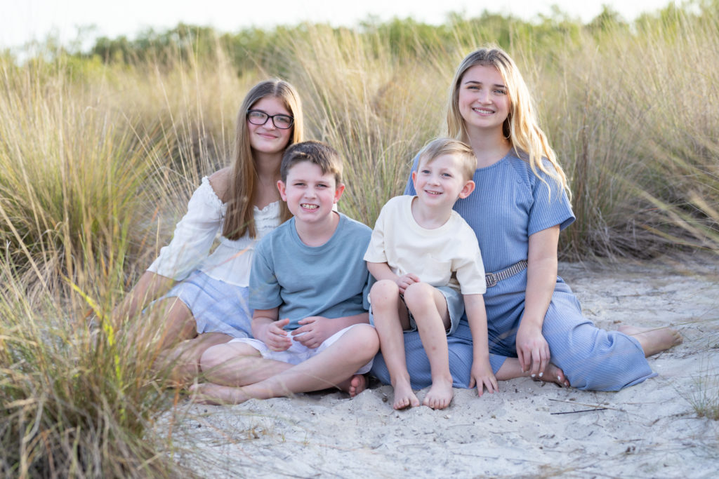 siblings in tall grass