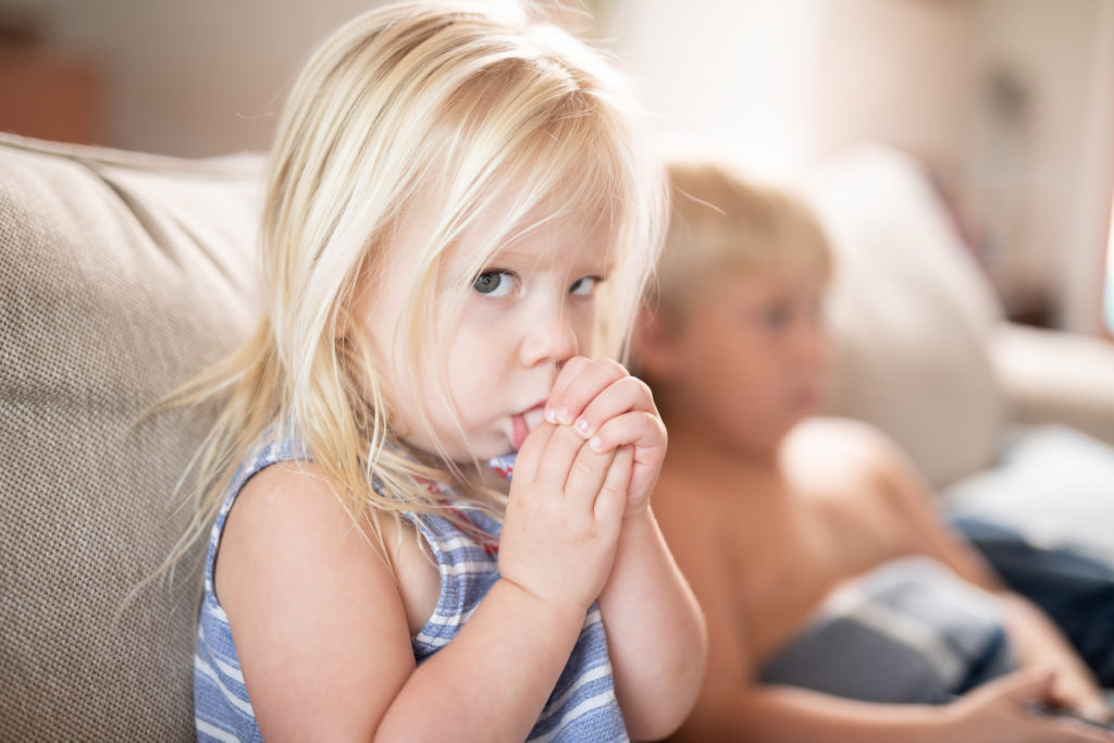 little girl sucking her thumb