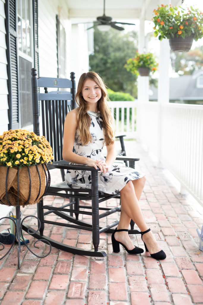 girl in rocking chair on front porch