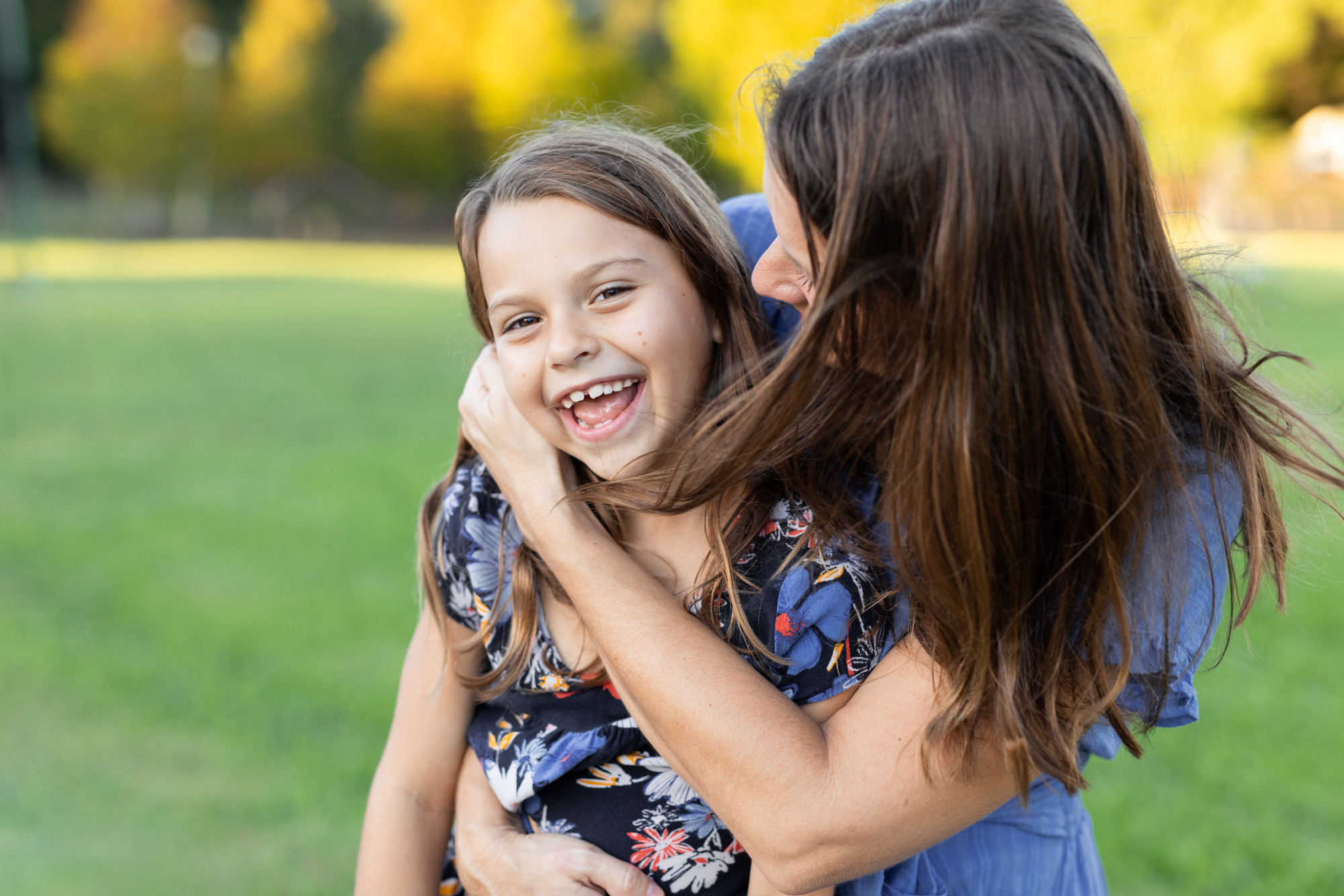Mom hugging daughter at park