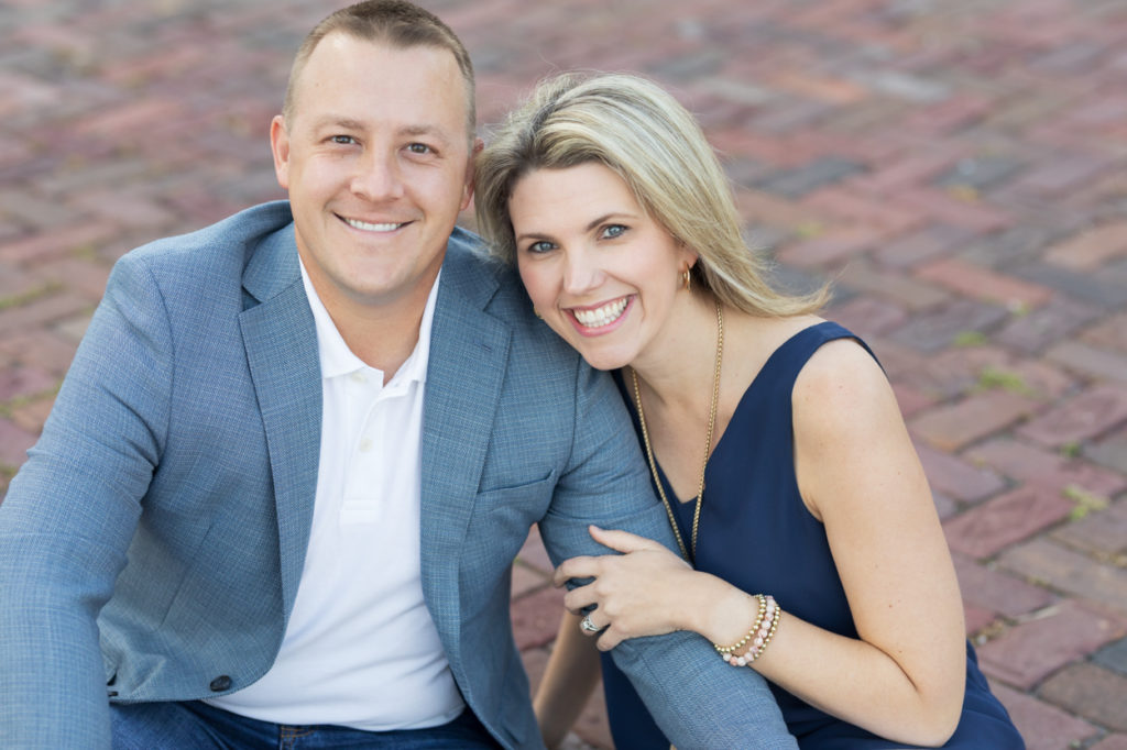 couple sitting on brick pavers