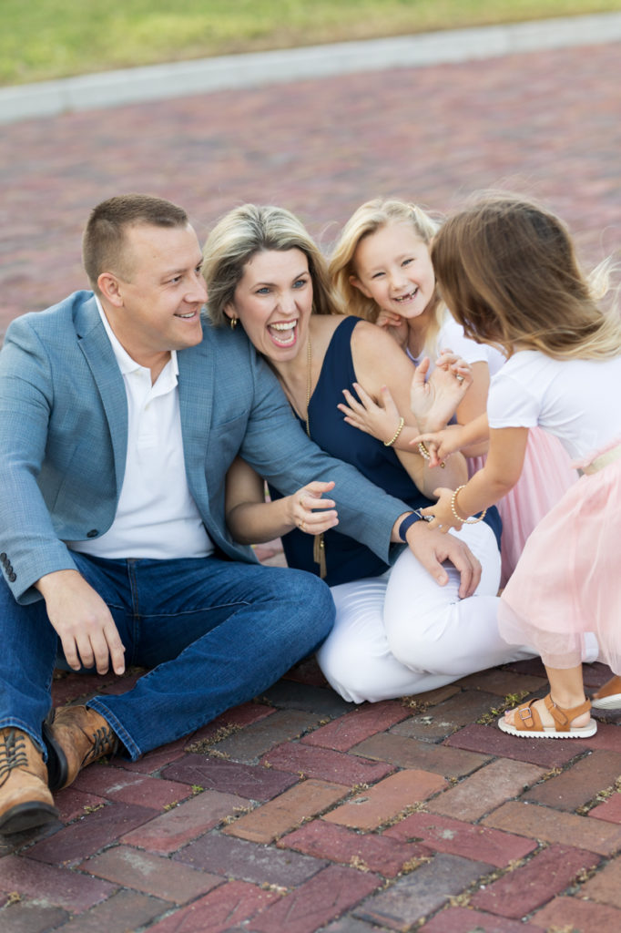 Palm Harbor family photographer girls running and jumping on parents