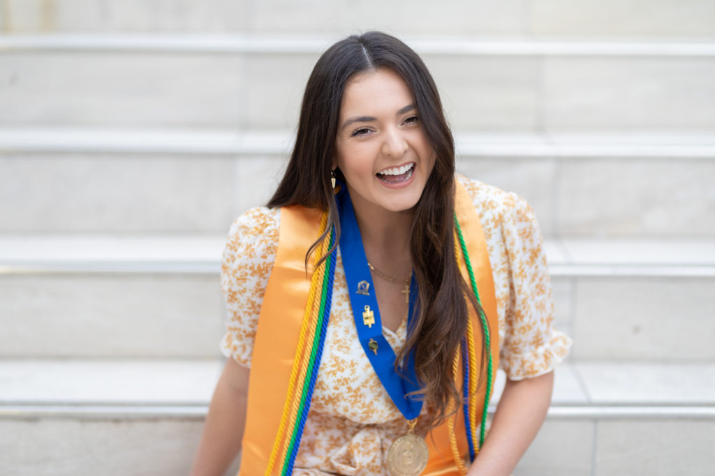 graduate laughing on steps