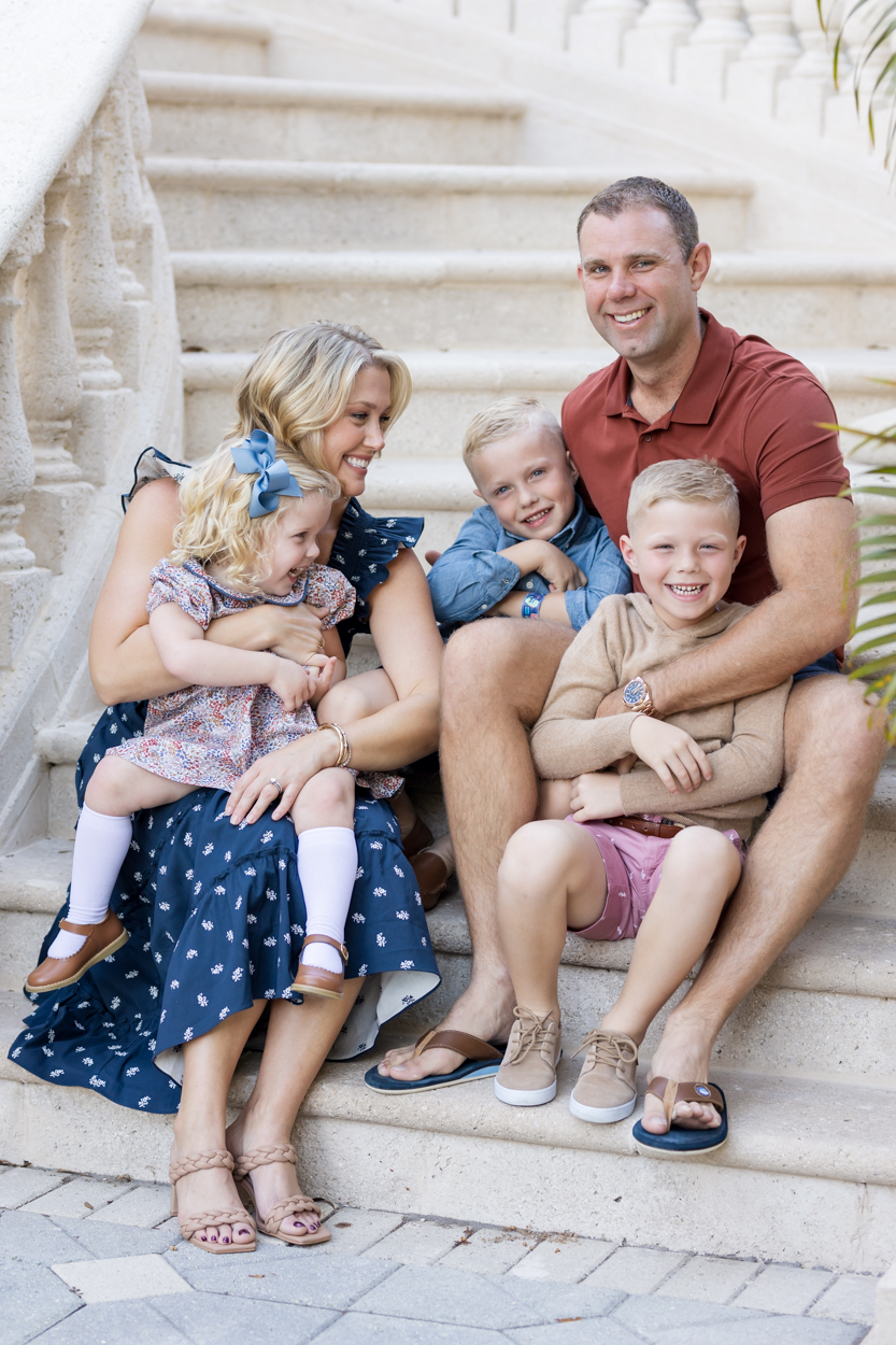 Family laughing on grand staircase