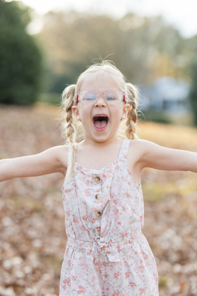 tampa family photographer excited girl in fall leaves