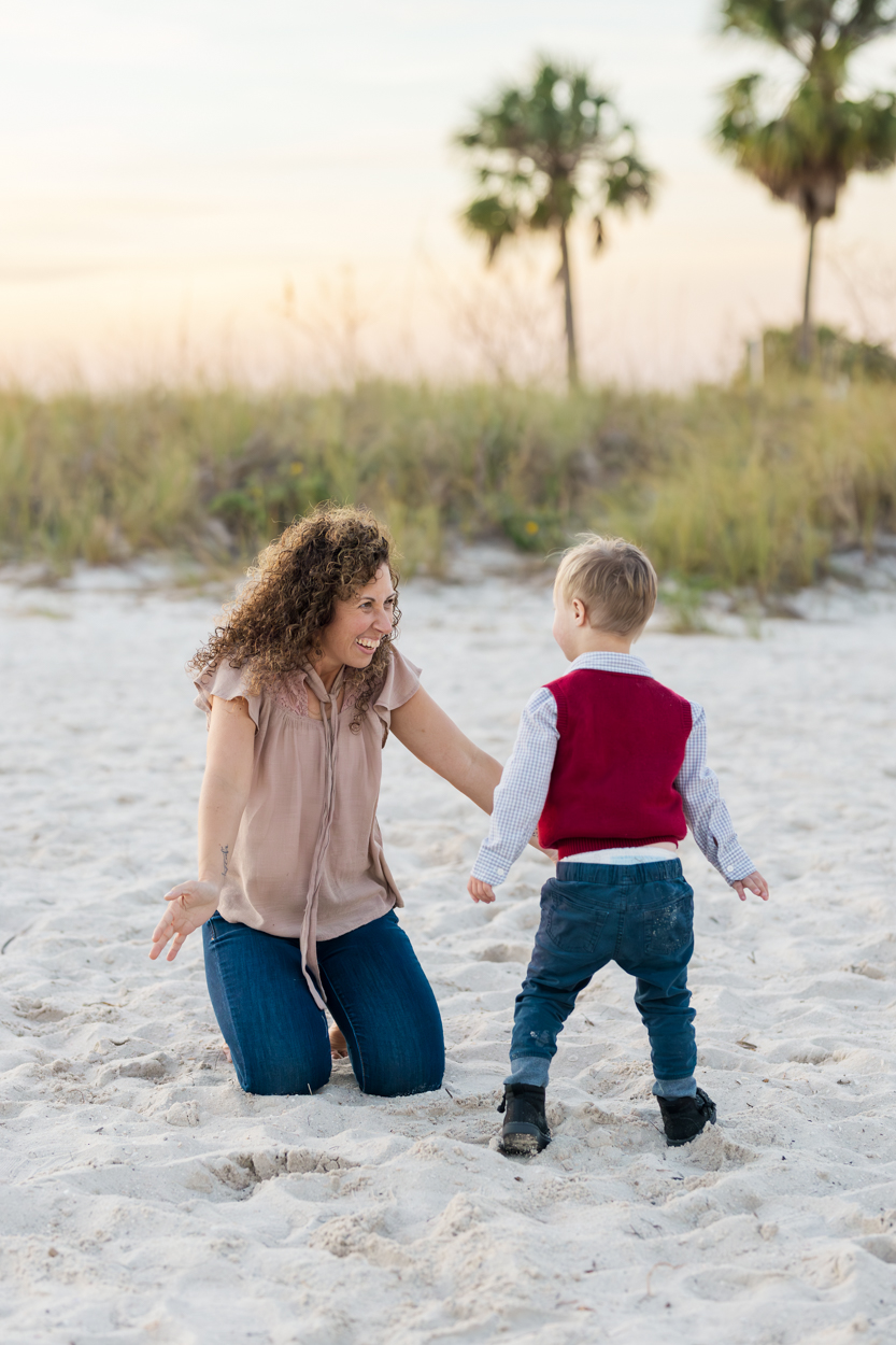 mom playing with son at the beach