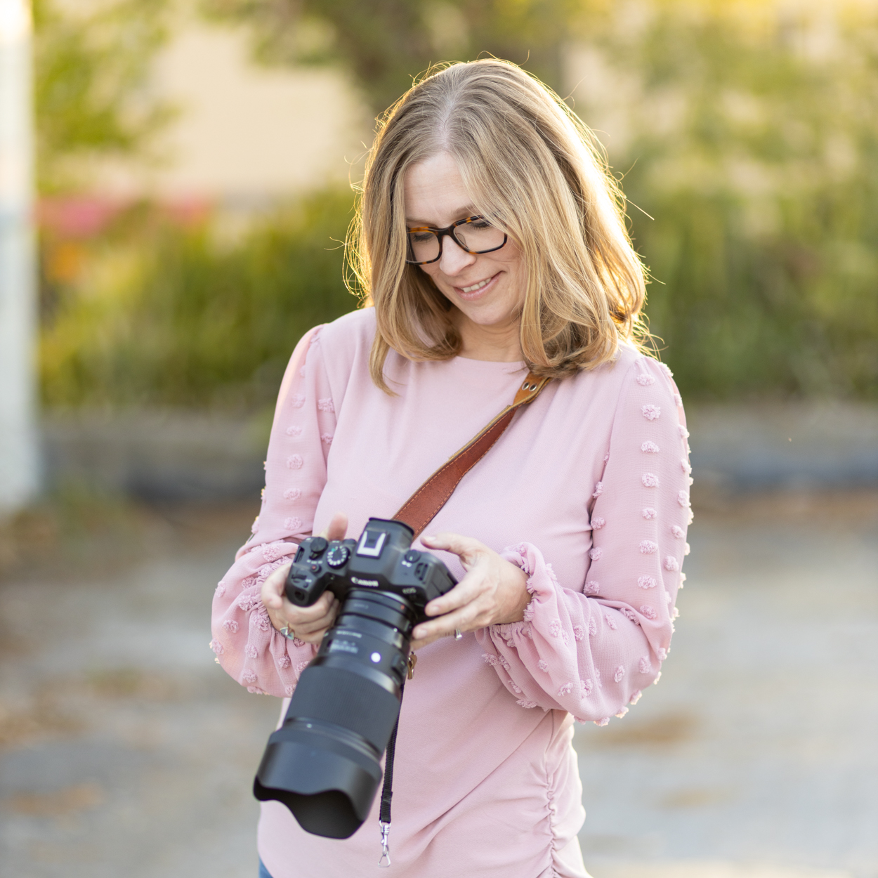 photographer looking at back of camera