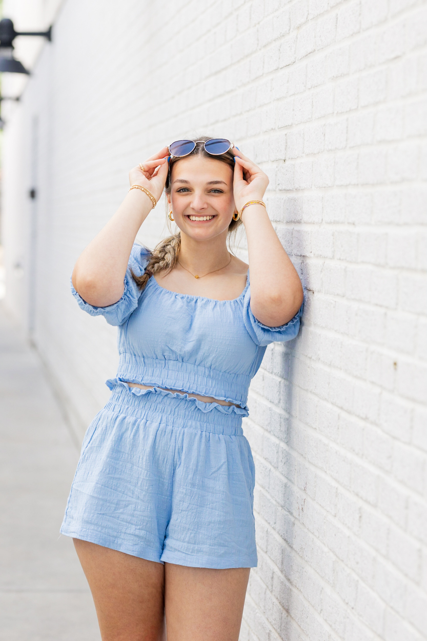 girl taking off sunglasses