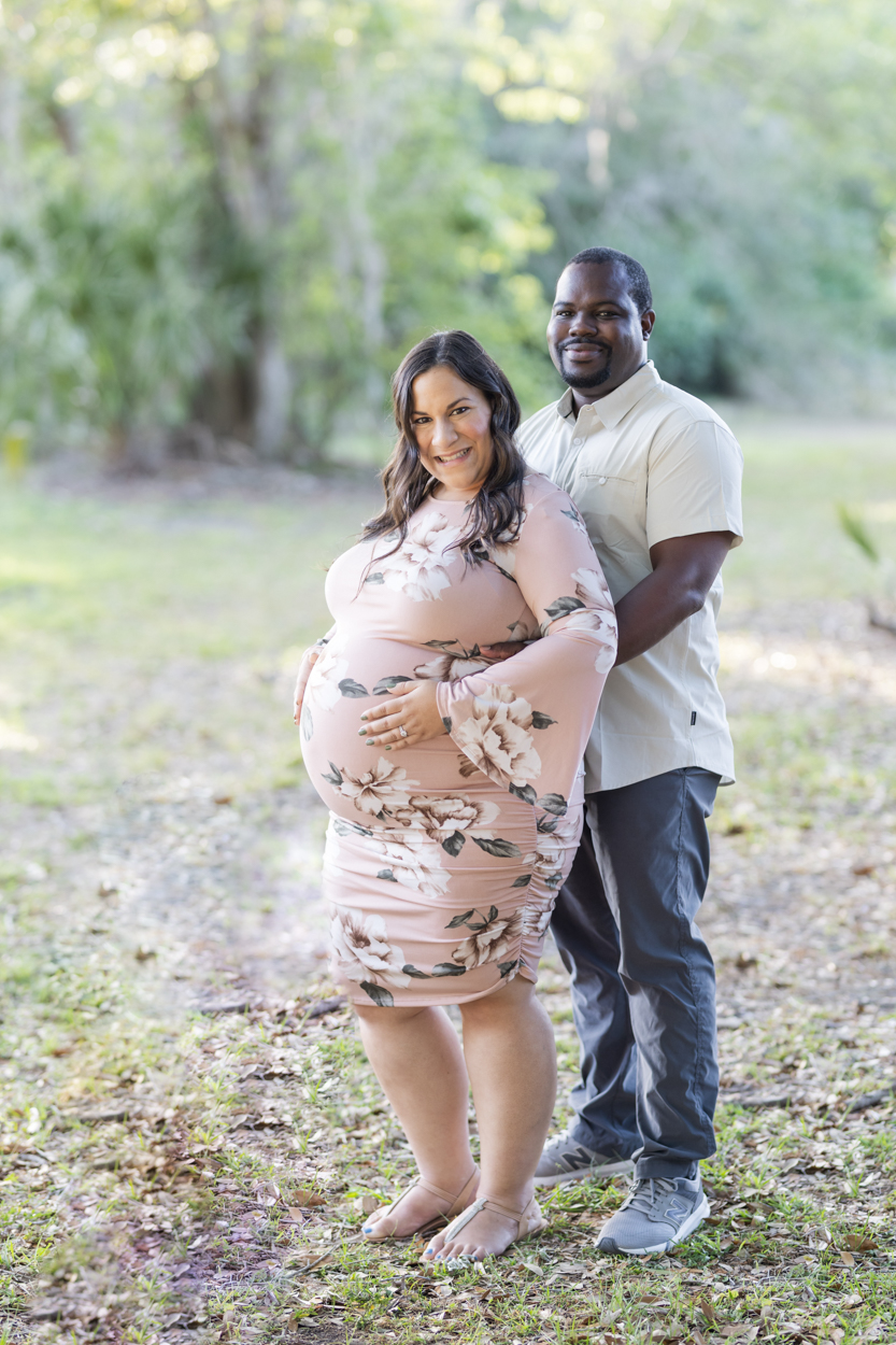 expecting parents posing for photos