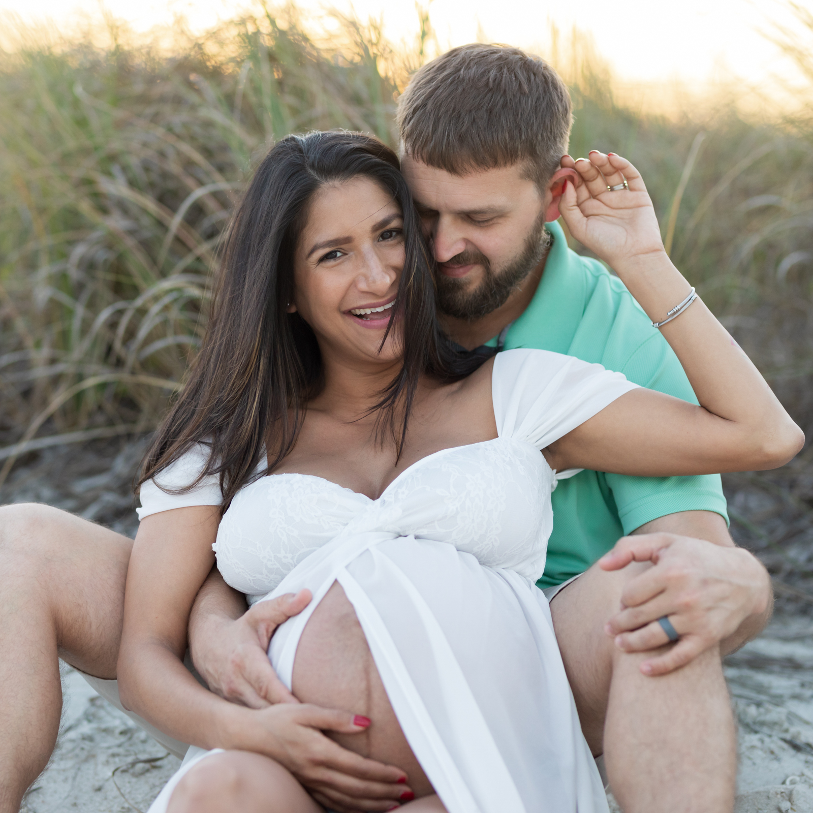 expecting mom laughing with her husband