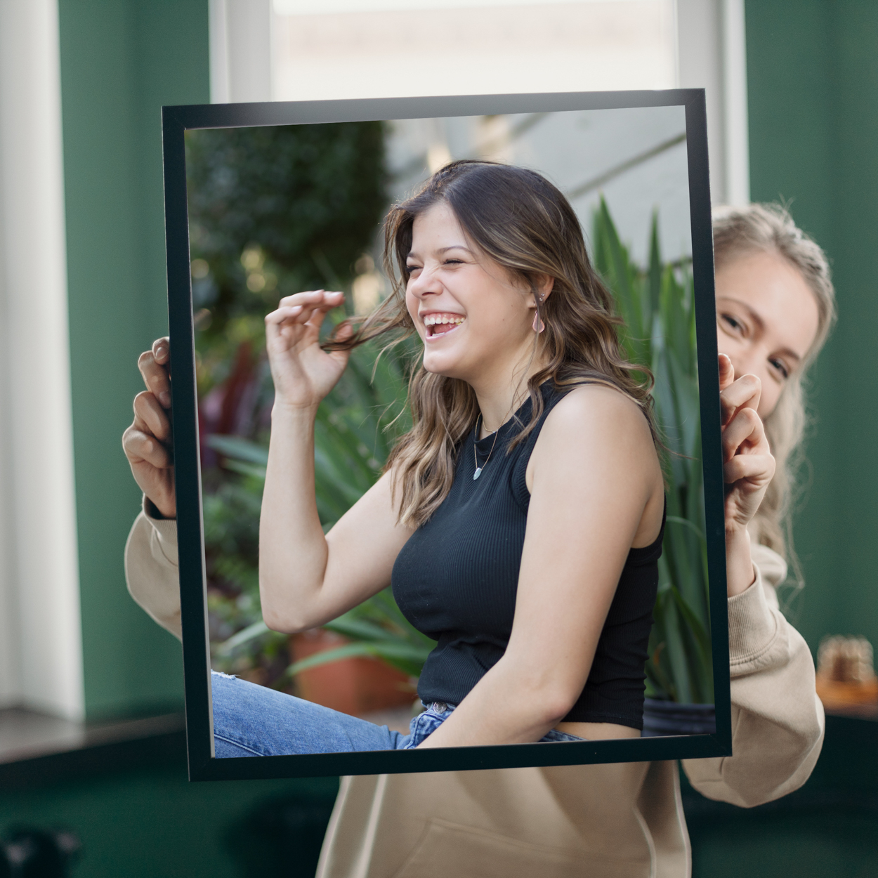 girl holding a large framed print