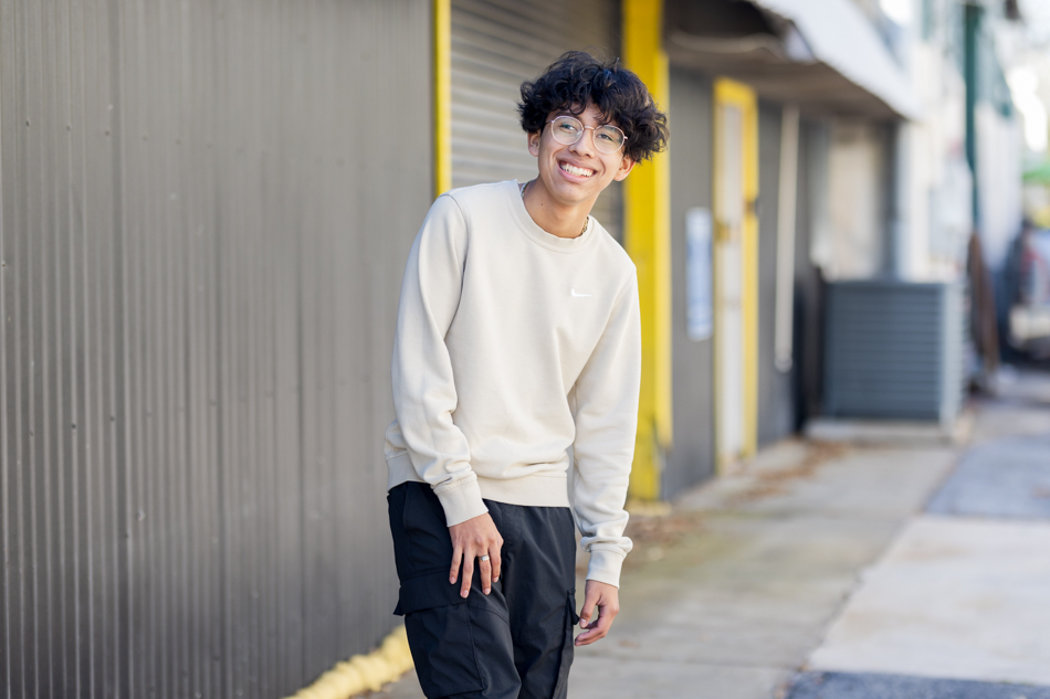 boy walking in front of uran building