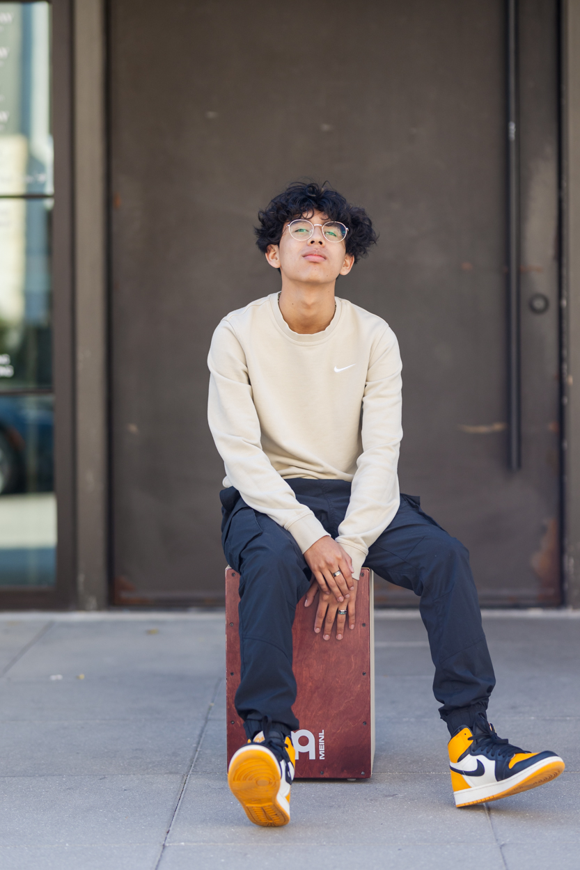 boy sitting on box drum