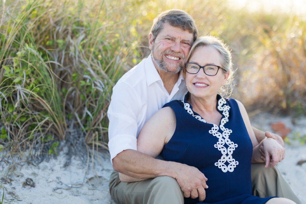 older couple smiling at the beach