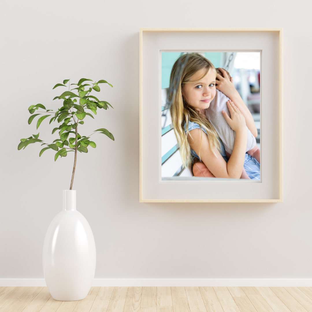 framed print of sister holding her baby brother