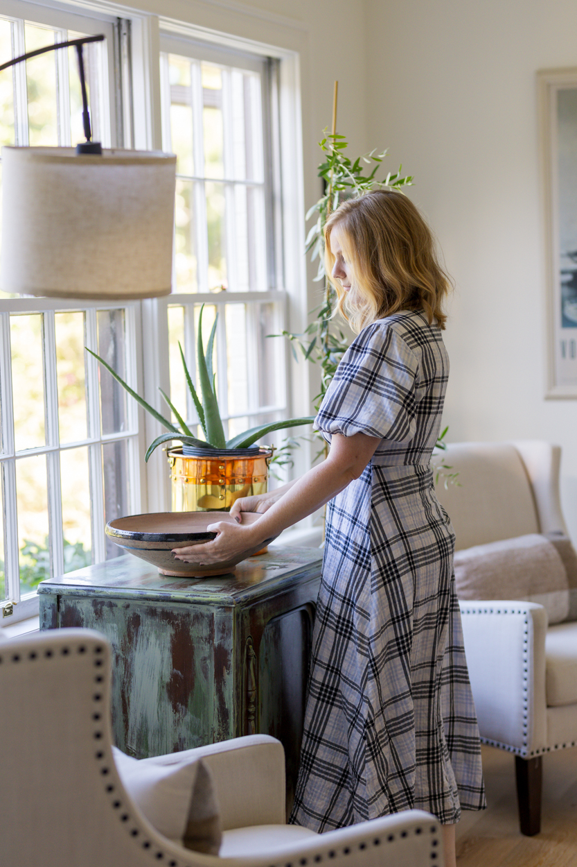 interior designer rearranging decor