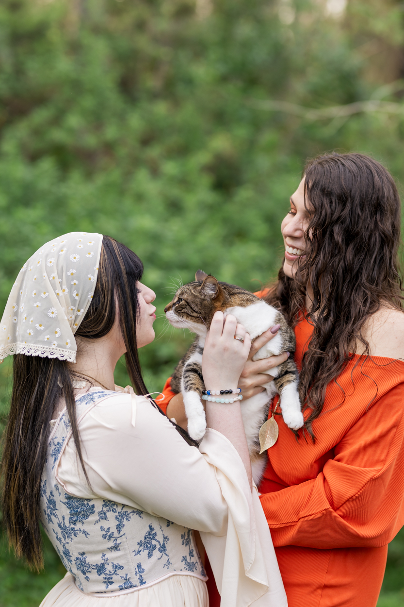 east lake family photographer girl and mom kissing their cat