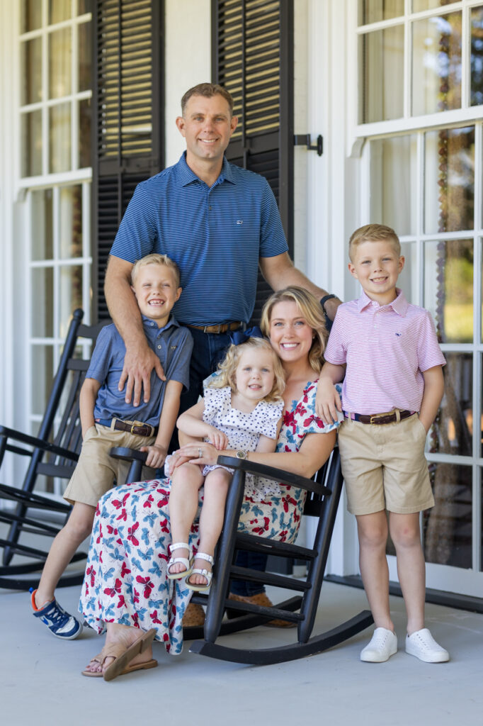 family posing for photo on the front porch