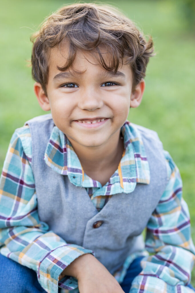 natural light portraits palm harbor boy in vest smiling at camera