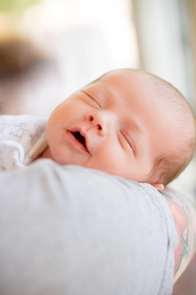 natural light newborn photographer tampa happy newborn asleep on mom