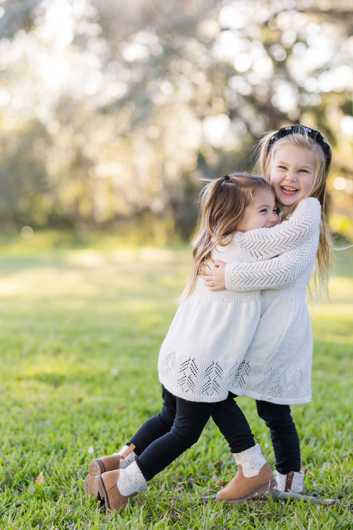 girls hugging at a park