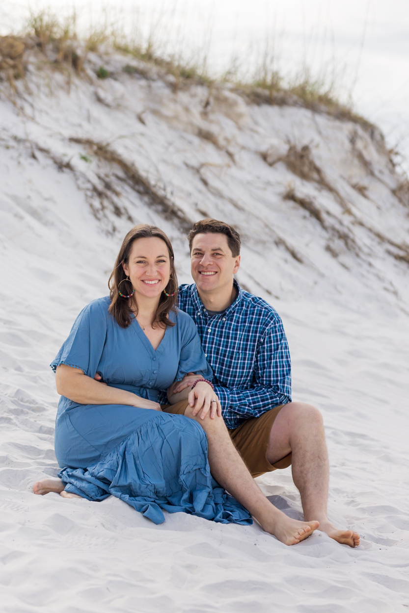 couple sitting by beach dune
