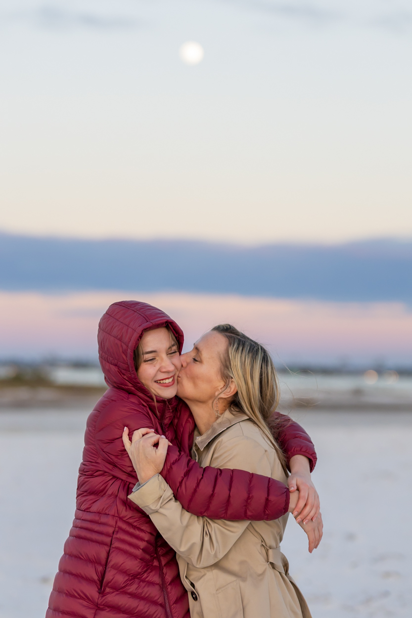 mom and teen daughter on the beach