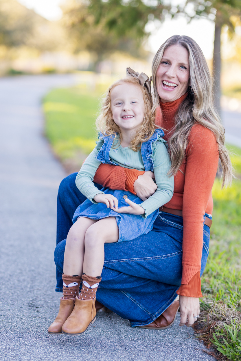 Mom holding daughter on lap