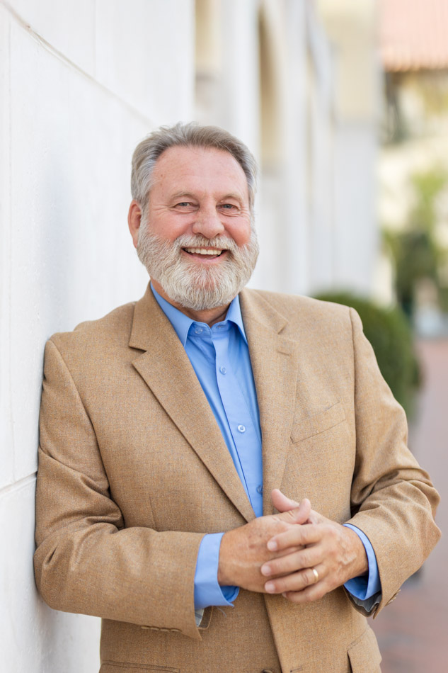 business man leaning on wall