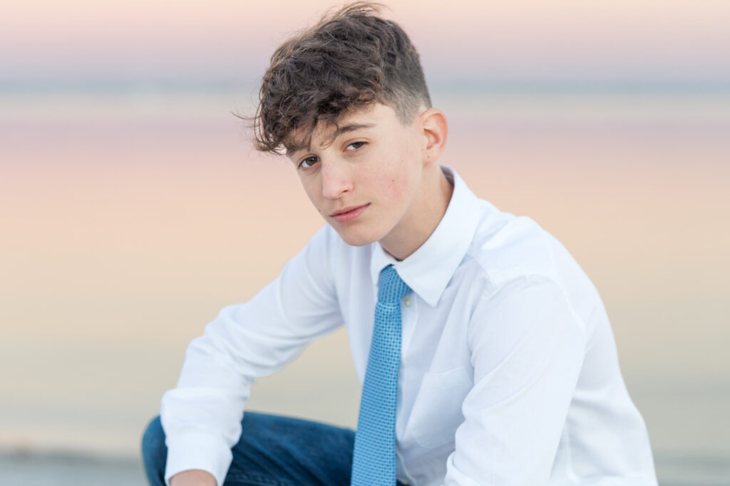 boy in front of pink sunset