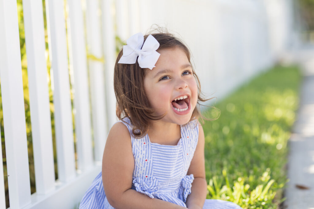 girl sitting on brick wall