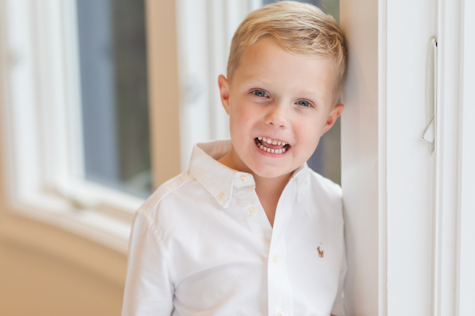 boy in white button down laughing