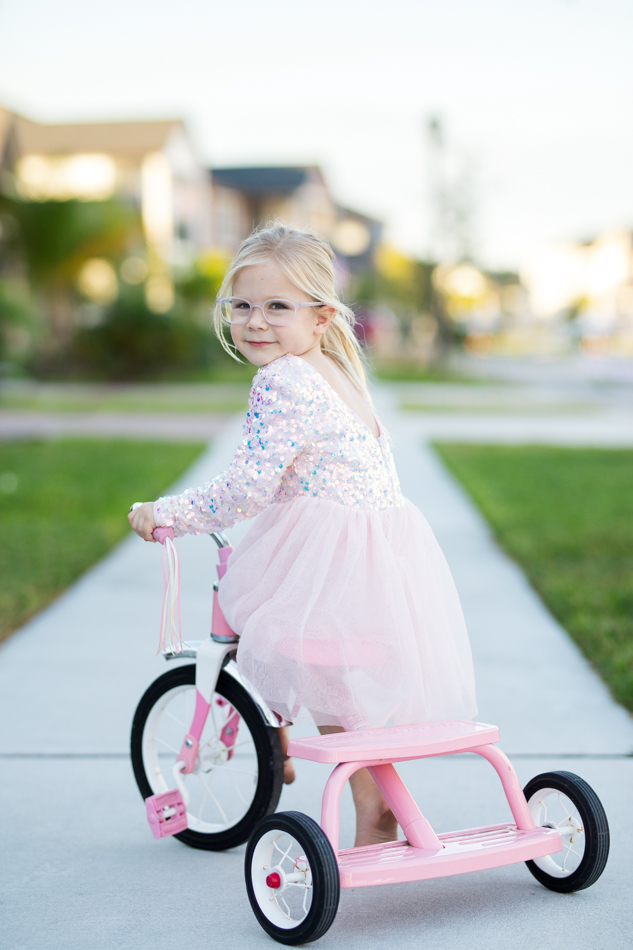 girl riding vintage tricycle