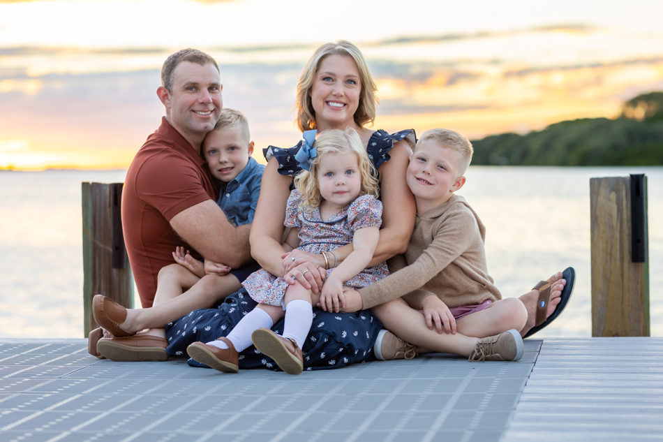 family of 5 snuggled up on the dock