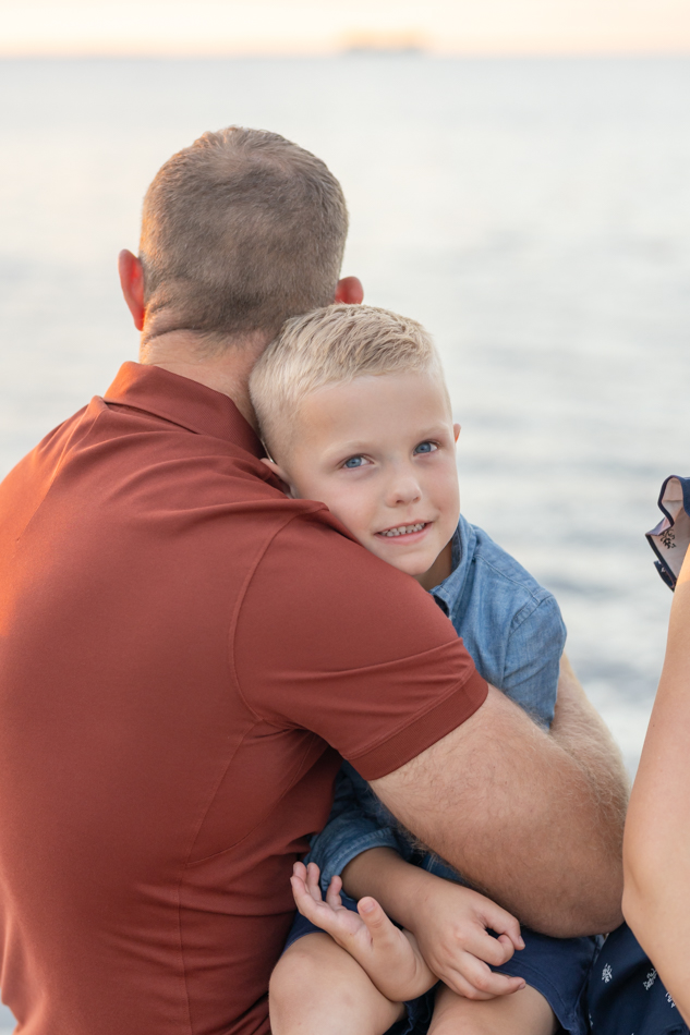 dad hugging son on dock