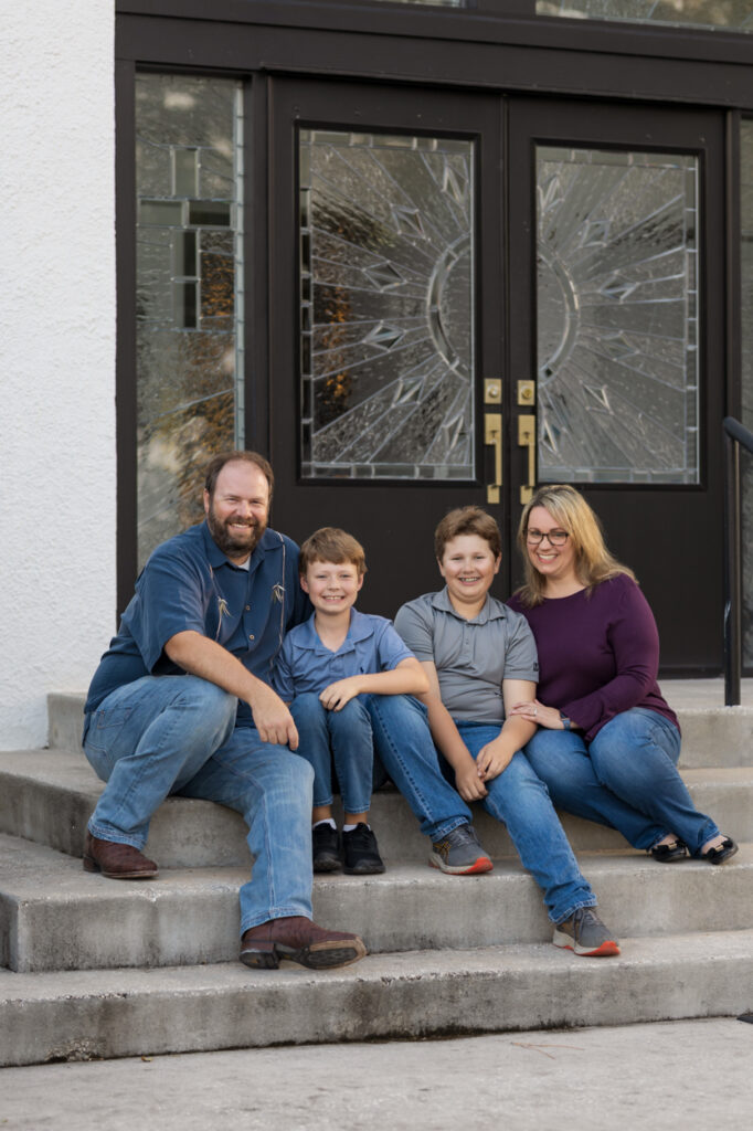 family sitting on steps for photos