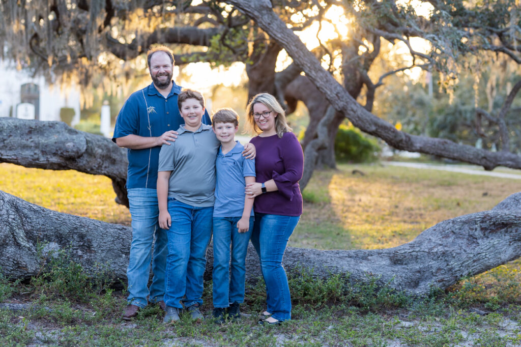 family of 4 posing for pictures in nature