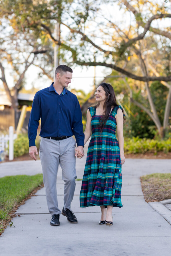 couple walking down sidewalk hand in hand