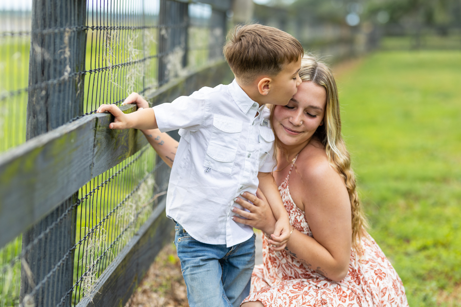 son kissing mom's forehead