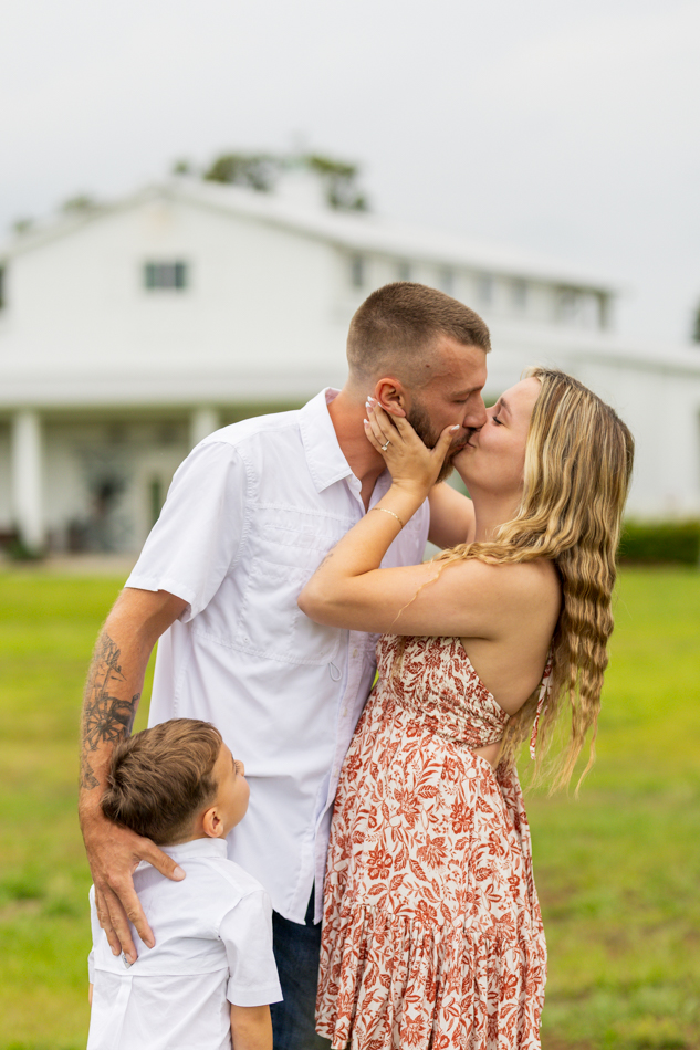 girl kissing her fiance with son hugging