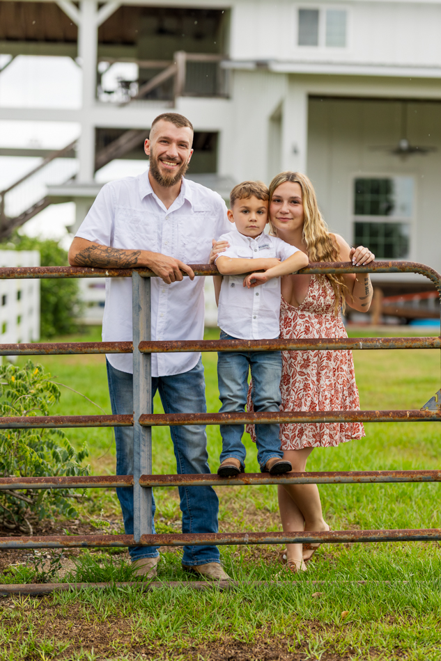 family leaning on metal fence