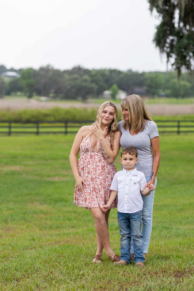 girl showing off her ring while mom looks on